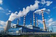 © Татьяна Евдокимова - Coal fired power station emitting smoke from its chimneys, releasing pollution into the atmosphere on a sunny day