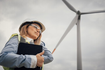 Poster - A skilled and professional female engineer is expertly overseeing a significant wind turbine project that focuses on promoting sustainability and harnessing renewable energy sources for the future