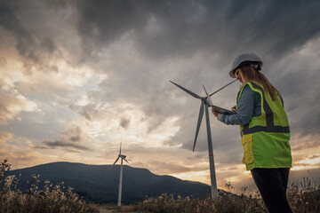 Poster - In a scenic landscape, a wind energy professional inspects large turbines that generate electricity, significantly contributing to renewable energy solutions that benefit the environment