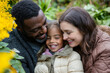 © Fabio - Diverse family taking a family portrait in a garden