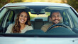 © Ali Hamza Tullah - Front portrait of happy couple sitting in luxury car, man and woman enjoying road trip or buying new car, smiling at camera, windshield view