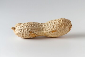 Wall Mural - A single peeled peanut sitting on a white surface