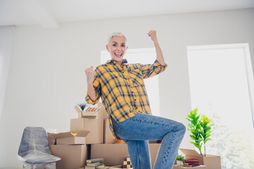 Poster - Photo of nice aged woman shout yes raise fists wear checkered shirt relocate move new apartment indoors