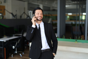 Sticker - A man in a suit is talking on his cell phone. He is smiling and he is in a good mood