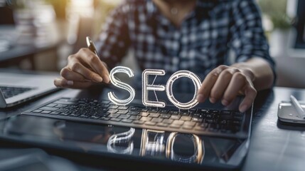 Poster - A person is writing the word SEO on a laptop keyboard