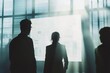 © Ben - Silhouettes of business professionals engaging in discussion at a whiteboard, brainstorming creatively in a collaborative workspace. Bright natural light enhances the minimalist office design, featuri