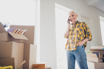 Canvas Print - Photo of nice aged woman speak phone wear checkered shirt relocate move new apartment indoors