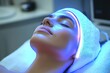 © Lamina - Woman relaxing during a beauty treatment with blue LED light therapy, enjoying a calming skincare session.