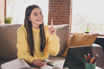 Canvas Print - Photo of charming teen girl sit sofa do homework online eureka excited wear yellow clothes modern interior flat indoors