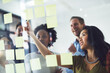 © SunriseDon/peopleimages.com - Idea, brainstorming and business people in meeting for planning, discussion and task schedule in office. Creative, startup and workers with sticky notes on glass for teamwork, research and project