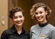 © ProArt Studios - Two hotel staff standing together, happy smilling.