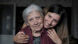 © dlogvin - Smiling caucasian woman lovingly embraces and hugs her elderly old grandmother, meeting after being quarantined due to coronavirus pandemic. Close up portrait gaze look at camera. Caring for relatives
