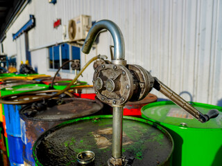 Old oil drums lined up in a chemical storage area. Oil suction cups and various types of oil drums. Diesel, gear oil and various types of lubricants.