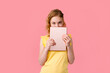 © Lena May - A teenage girl does her homework on a tablet. The student works and communicates with friends