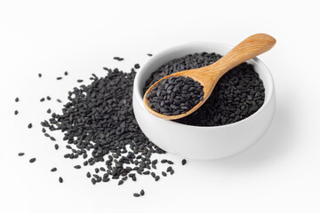 Wall Mural - Black sesame in wood spoon on white bowl with heap of black sesame seeds isolated on white background