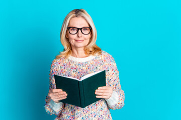 Canvas Print - Portrait of pretty aged lady hold book empty space wear sweater isolated on turquoise color background