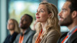© Nia - People at a conference, focusing intently on presentations and discussions in a professional environment.