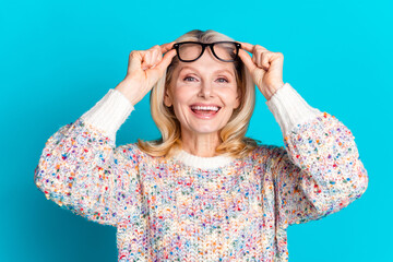 Wall Mural - Portrait of pretty aged lady touch eyeglasses wear sweater isolated on turquoise color background