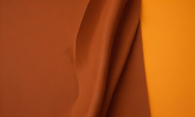Leinwandbilder - a close-up view fabric with a reddish-brown hue, partially folded and overlapping with a contrasting orange background