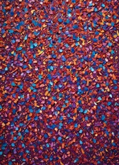Leinwandbilder - A vibrant abstract composition of multicolored confetti, with a mix of red, orange, yellow, blue, and purple hues, creating a dynamic and visually striking pattern