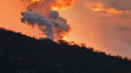 Poster - Massive explosion erupts, sending black smoke into the sky, illuminated by the setting sun. The image serves as a reminder of pollution, global warming, and threats of war and terrorism