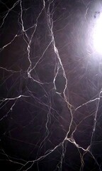 Aufkleber - a close-up view dark, textured surface resembling a marble or stone wall The surface has a dark, cracked appearance, with visible cracks and crevices The does