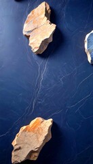 Poster - Three large rocks of varying sizes and colors are arranged on a dark blue background, with a subtle pattern of lines and cracks