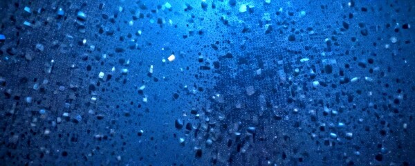Poster - a close-up view dark blue surface with numerous small, irregularly shaped white and gray objects scattered across it, creating a textured and abstract pattern