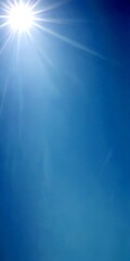 Poster - The sun shines brightly in the clear blue sky, casting a radiant beam of light that illuminates the scene