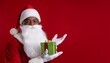 © Abdul - Close-up photo of Santa Claus holding a gift with a plain color background