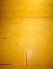 Aufkleber - A close-up view yellow tiled floor, with a grid-like pattern of square tiles