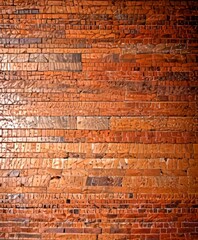 Fototapete - a close-up view brick wall, with the bricks arranged in a pattern that creates a textured and visually interesting surface