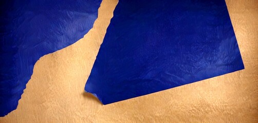 Leinwandbilder - a close-up view piece of blue paper with a tear, set against a textured beige background