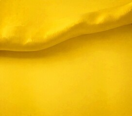 Poster - A close-up view yellow fabric, with a slight curve and a smooth texture, creating a visually appealing contrast