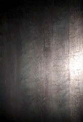 Fototapete - a dark, textured surface with a faint, glowing light source on the right side, creating an atmospheric and mysterious mood
