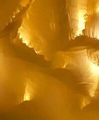 Poster - a close-up view textured surface with a golden hue, resembling the appearance of frost or ice The surface has a rough, uneven texture, and the golden color is