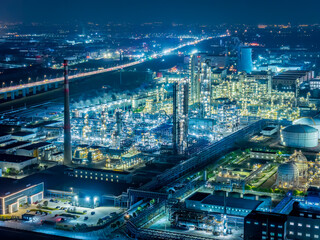 Oil refinery chemical plant industrial equipment buildings at night