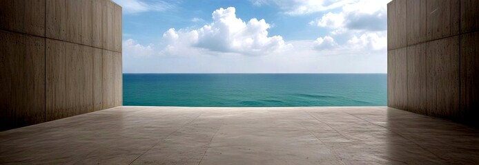 Poster - A minimalist architectural design with a concrete floor and two concrete walls framing a view of the ocean and a cloudy sky