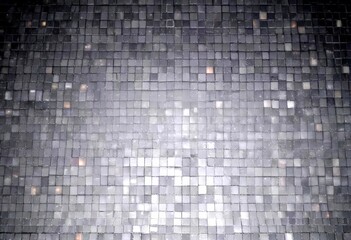 Aufkleber - a close-up view dark gray mosaic floor composed of small square tiles, creating a textured and visua