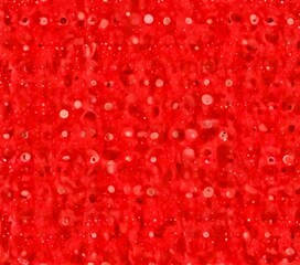 Aufkleber - a pinkish-red textured background with small white dots scattered throughout, creating a visually interesting and abstract pattern