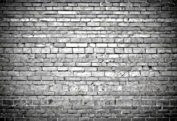 Aufkleber - A monochromatic brick wall, with varying shades of gray and black bricks arranged in a uniform pattern