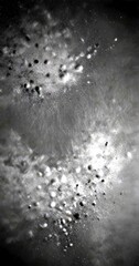 Aufkleber - a black and white photograph textured surface, with small white dots scattered across the frame