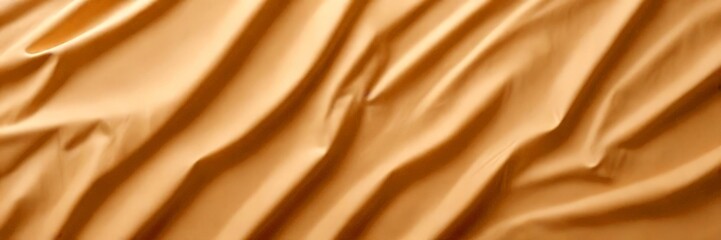 Aufkleber - a close-up view crumpled, beige-colored fabric, with the folds and creases creating a textured and dynamic appearance