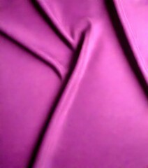 Poster - a close-up view fabric with a deep purple color, featuring a criss-cross pattern of folds and creases