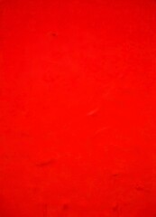 Leinwandbilder - a close-up view red surface with a slight texture, resembling a fabric or a canvas The color is vibrant and the background is blurred, drawing attention to the red surface