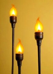 Aufkleber - Three black torches with flickering orange flames are arranged in a row against a yellow background
