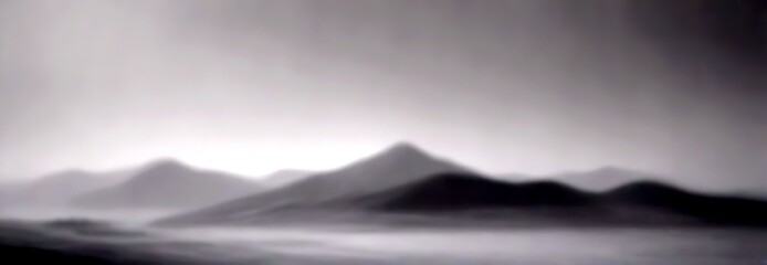 Aufkleber - a black and white photograph misty mountain landscape, with the mountains appearing as a hazy, blurred background