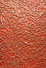 Leinwandbilder - a close-up view of a textured surface with a pattern of small, irregularly shaped holes or cavities in a vibrant orange color. The pattern is not uniform, with some