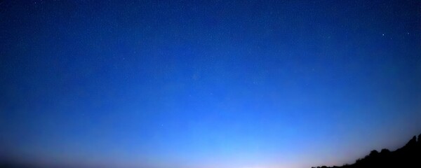 Poster - A starry night sky with a gradient of blue hues, featuring a few distant stars and a silhouette of trees in the bottom right corner.