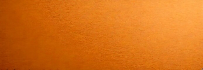Aufkleber - a close-up view of a textured orange surface, possibly a fabric or a wall, with a gradient effect transitioning from a lighter shade at the top to a darker one at the bottom.